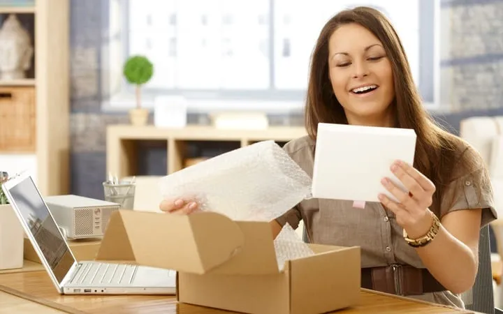 Woman unpack shipping box